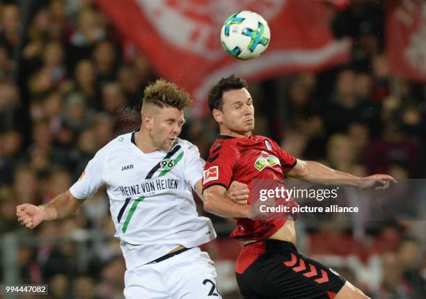 Freiburg's Nicolas Hoefler and Hanover's Niclas Fuellkrug vie for the ball during the German Bundesliga soccer match between SC Freiburg and Hannover...