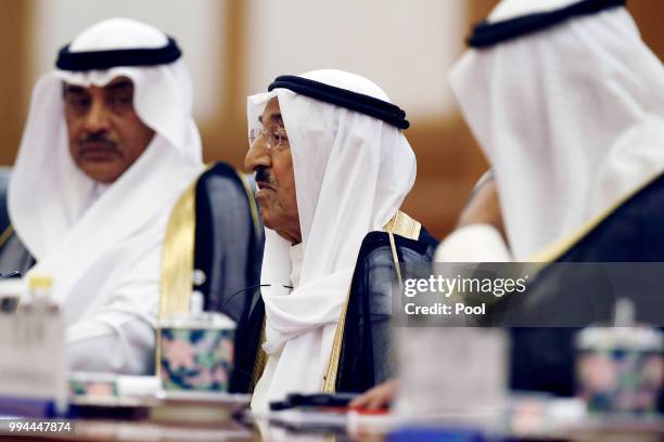 Kuwait's ruling emir, Sheikh Sabah Al Ahmad Al Sabah speaks during a meeting with Chinese President Xi Jinping at the Great Hall of the People on...