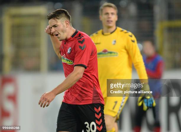 Freiburg's keeper Alexander Schwolow complains after conceding a goal during the German Bundesliga soccer match between SC Freiburg and Hannover 96...