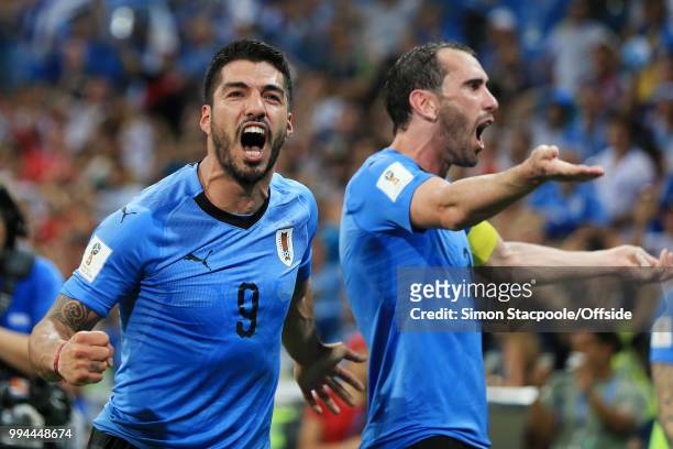 Luis Suarez of Uruguay celebrates victory with teammate Diego Godin of Uruguay after the 2018 FIFA World Cup Russia Round of 16 match between Uruguay...