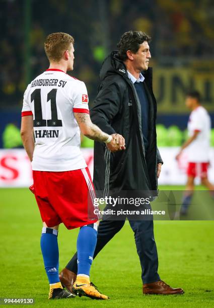 Gamburg's sports director Jens Todt and player André Hahn during the German Bundesliga soccer match between Hamburger SV and Borussia Dortmund in the...