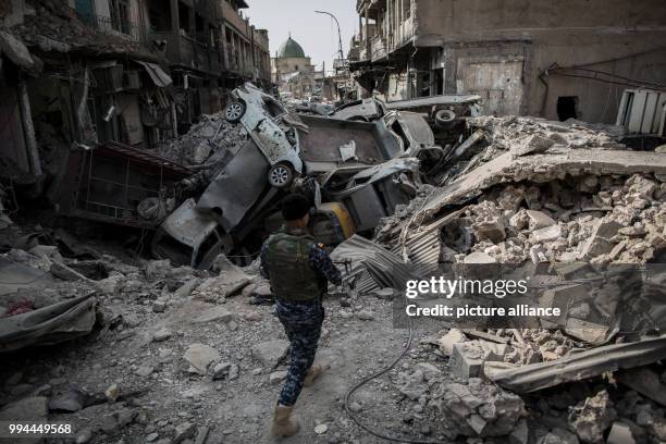An Iraqi police man negotiates debris in the old city of Mosul, Iraq, 21 September 2017. After almost nine months of heavy fighting Mosul was...