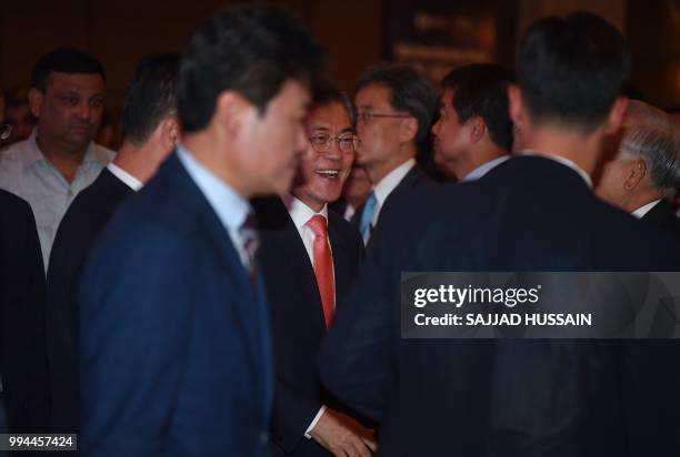 South Korea's President Moon Jae-in arrives to deliver a speech at the 'India-Korea Business Forum' in New Delhi on July 9, 2018. - The event was...