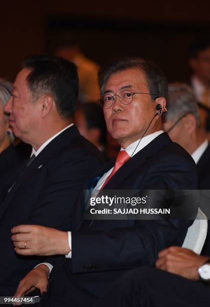 South Korea's President Moon Jae-in gestures before his speech at the 'India-Korea Business Forum' in New Delhi on July 9, 2018. - The event was...