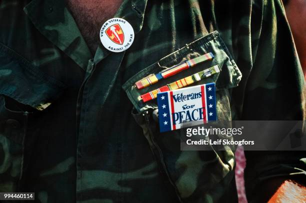 Close-up of military service ribbons and buttons on the fatigues of a Vietnam War veteran as he attends the Vietnam Veterans Against the War...