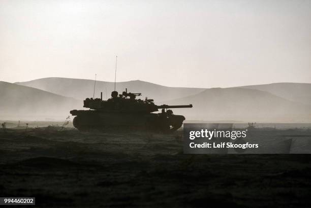 Silhouette of an M1 Abrams battle tank during maneuvers at the National Training Center at Fort Irwin, California, 1994.