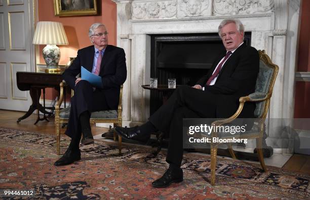 Michel Barnier, chief negotiator for the European Union , left, listens as David Davis, U.K. Exiting the European Union secretary, speaks during a...