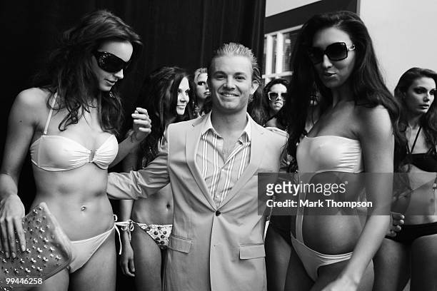 Nico Rosberg of Germany and Mercedes GP models at the Amber Fashion Show and Auction held at the Meridien Beach Plaza on May 14, 2010 in Monte Carlo,...