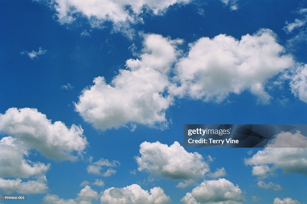 Sparse cumulus cloud in blue sky, ground view