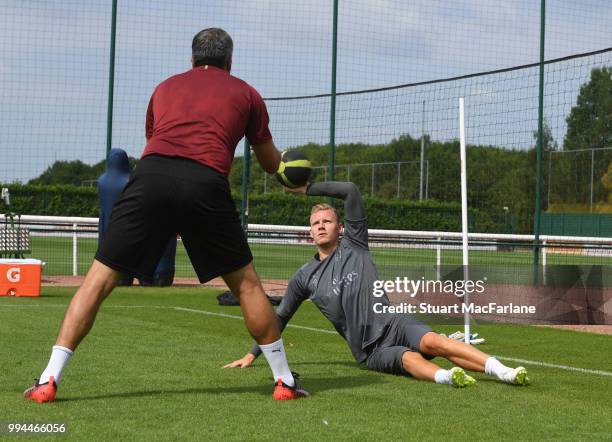 Arsenal goalkeeper Bernd Leno with coach Sal Bibbo during a training session at Colney on July 9, 2018 in St Albans, England.