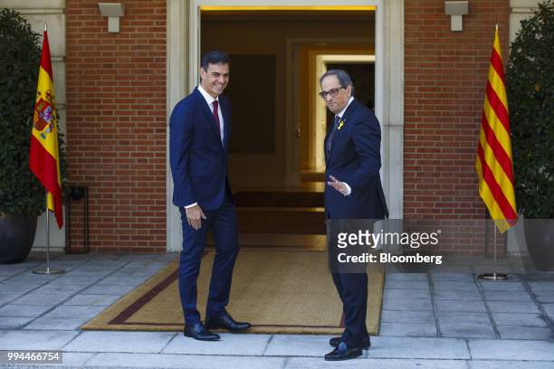 Joaquim Torra, Catalonia's president, right, stands beside Pedro Sanchez, Spain's prime minister, ahead of their meeting at Moncloa palace in Madrid,...