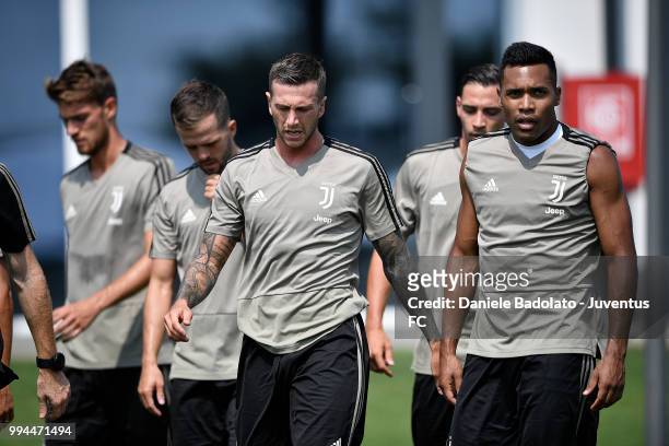 Federico Bernardeschi and Alex Sandro during a Juventus training session at Juventus Training Center on July 9, 2018 in Turin, Italy.