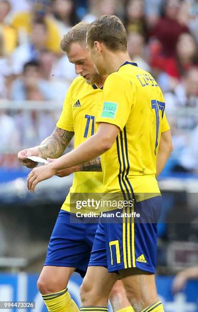 John Guidetti, Viktor Claesson of Sweden read a note given by their coach in the middle of the 2018 FIFA World Cup Russia Quarter Final match between...