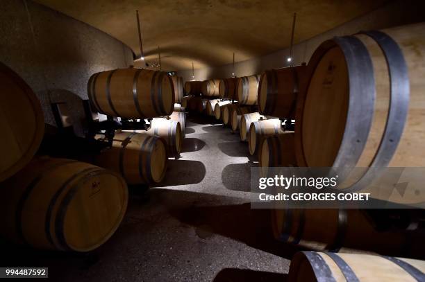 Picture taken on July 5, 2018 in Saint Emilion near Bordeaux shows barrels in the winery at the Chateau La Grace Dieu des Prieurs estate, owned by...