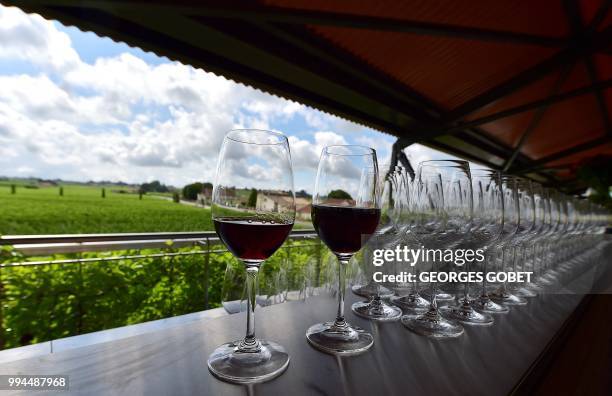 Picture taken on July 5, 2018 in Saint Emilion near Bordeaux shows glasses of wine at the Chateau La Grace Dieu des Prieurs estate, owned by Russian...