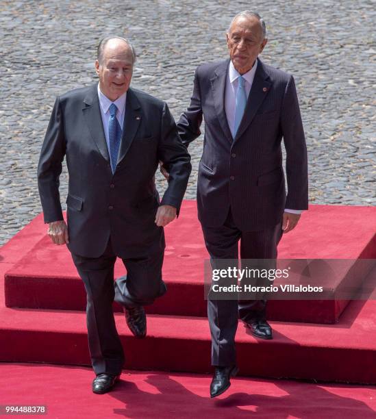 Portuguese President Marcelo Rebelo de Sousa helps Shah Karim Al-Hussaini, Prince Aga Khan , down the steps while going to salute the Portuguese flag...