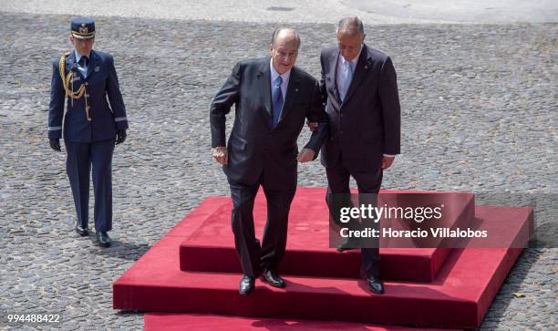 Portuguese President Marcelo Rebelo de Sousa helps Shah Karim Al-Hussaini, Prince Aga Khan , down the steps while going to salute the Portuguese flag...