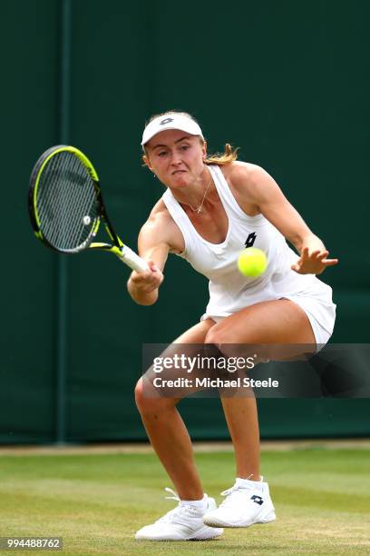 Aliaksandra Sasnovich of Belarus plays a forehand against Jelena Ostapenko of Latvia during their Ladies' Singles fourth round match on day seven of...