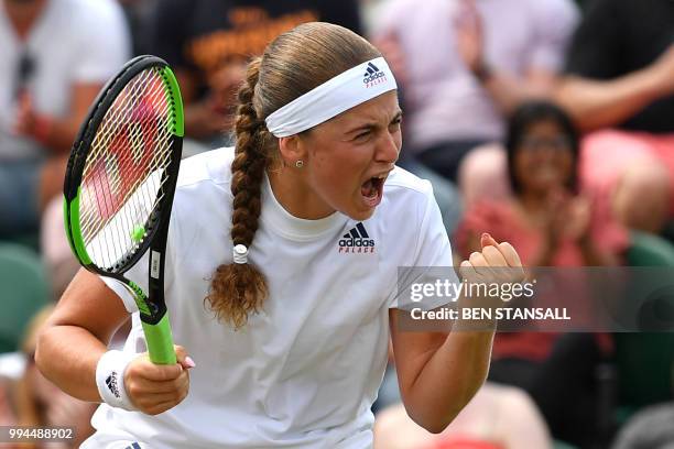 Latvia's Jelena Ostapenko celebrates a point against Belarus' Aliaksandra Sasnovich in their women's singles fourth round match on the seventh day of...