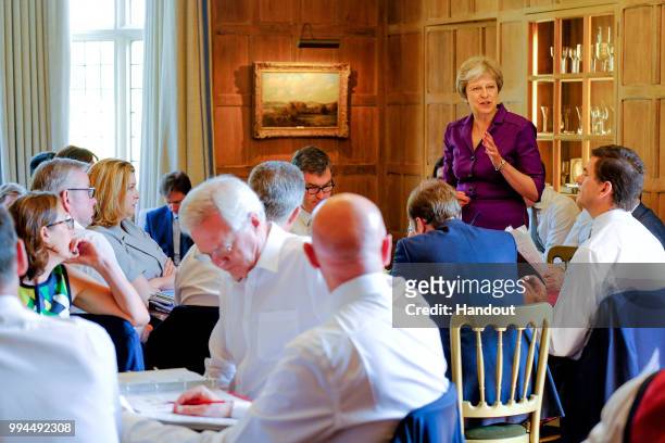 In this handout from the Prime Minister's Office, Prime Minister Theresa May and members of her Cabinet meet at her country retreat Chequers on July...
