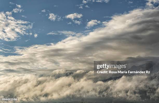 scenic view of cloudscape against mountain peak - rz stock pictures, royalty-free photos & images