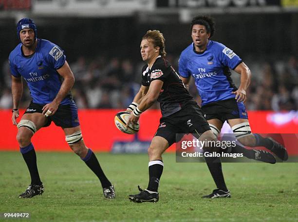 Charl Macleod looks to pass the ball away from Nathan Sharpe and Sam Wykes during the Super 14 match between the Sharks and Western Force held at...