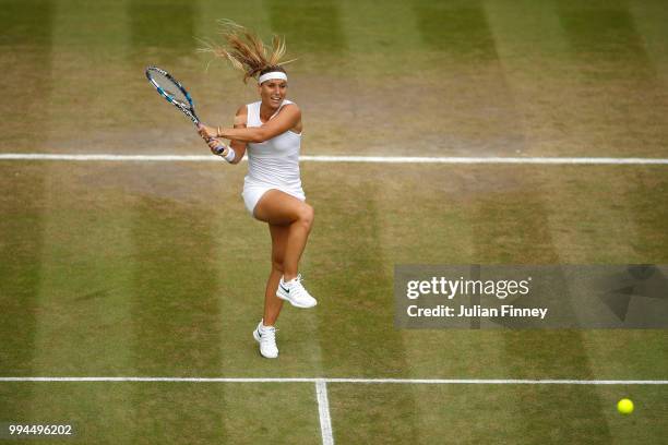 Dominika Cibulkova of Slovakia plays a backhand against Su-Wei Hsieh of Chinese Taipei during their Ladies' Singles fourth round match on day seven...