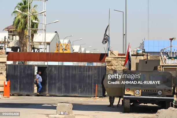 An Iraqi security forces' humvee is seen parked outside a warehouse where ballots from the May parliamentary election are stored in the capital...
