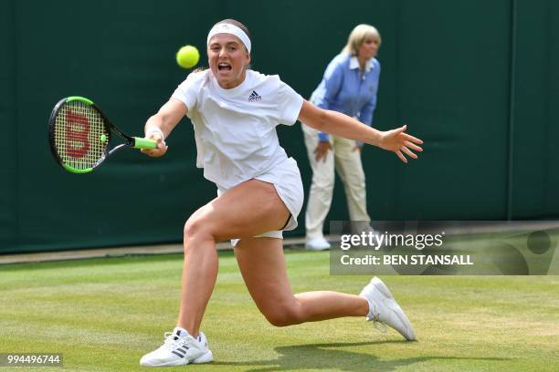 Latvia's Jelena Ostapenko returns to Belarus' Aliaksandra Sasnovich in their women's singles fourth round match on the seventh day of the 2018...