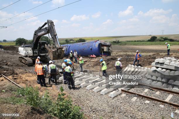 Workers repair the railroad at the Sarilar village of Tekirdags Corlu district on July 09, 2018. The train, carrying 362 passengers and six train...