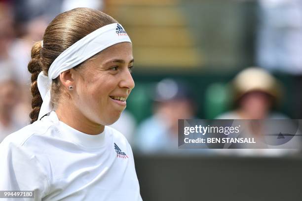 Latvia's Jelena Ostapenko reacts while playing Belarus' Aliaksandra Sasnovich in their women's singles fourth round match on the seventh day of the...