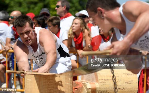 Participants saw a tree trunk with a "tronza", a traditional Basque saw, during a rural Basque sports championship on the third day of the San Fermin...