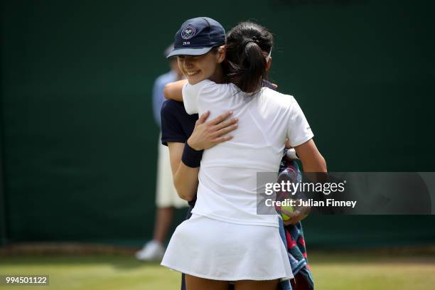 Su-Wei Hsieh of Chinese Taipei hugs a ballkid in her Ladies' Singles fourth round match against Dominika Cibulkova of Slovakia on day seven of the...