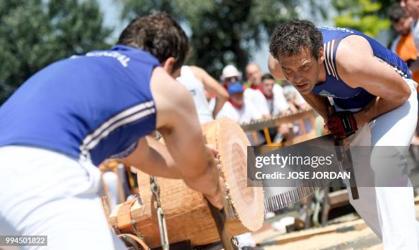 Participants saw a tree trunk with a "tronza", a traditional Basque saw, during a rural Basque sports championship on the third day of the San Fermin...