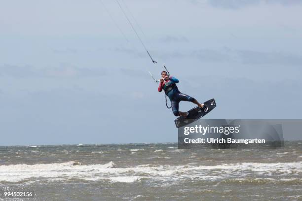 Trendsport kite surfing on the North sea coast in St. Peter Ording and the concerns about the habitat of the birds on this strech of coast in the...