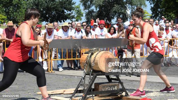 Participants saw a tree trunk with a "tronza", a traditional Basque saw, during a rural Basque sports championship on the third day of the San Fermin...