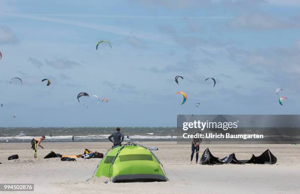 Trendsport kite surfing on the North sea coast in St. Peter Ording and the concerns about the habitat of the birds on this strech of coast in the...