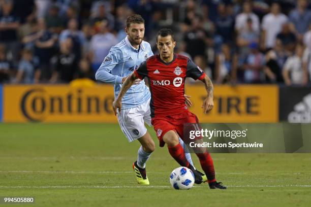Toronto FC forward Sebastian Giovinco gets past Sporting Kansas City midfielder Ilie Sanchez in the second half of an MLS match between Toronto FC...