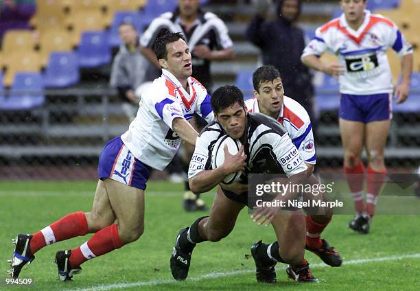 Stephen Kearney of New Zealand scores a try despite the tackle of Fabian Devecchi and Eric Anselme of France during the Rugby League Test Match...