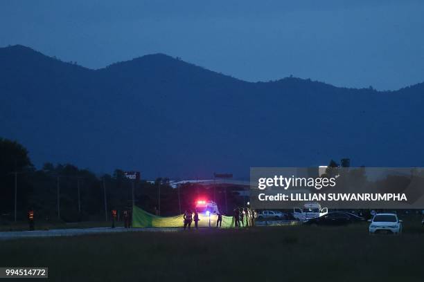 An ambulance arrive at a military airbase in Chiang Rai as helicopters approach to land during emergency evacuation while rescue operations continue...