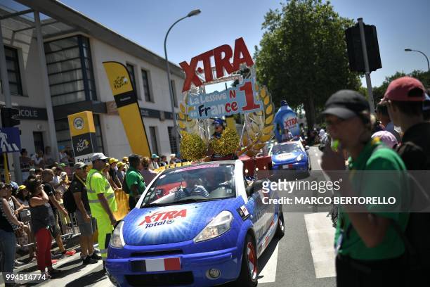 Cars of the race's publicity caravan, promoting washing powder, parade prior to the third stage of the 105th edition of the Tour de France cycling...