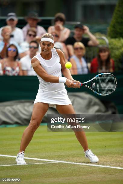 Dominika Cibulkova of Slovakia plays a backhand against Su-Wei Hsieh of Chinese Taipei during their Ladies' Singles fourth round match on day seven...