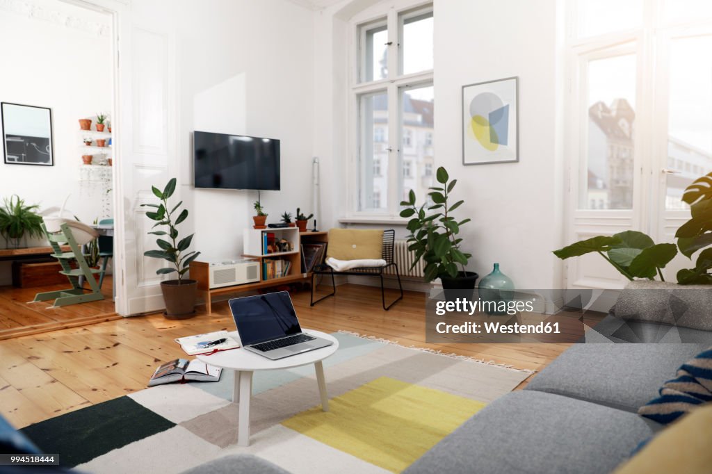 Laptop on a coffee table in a modernly furnished flat