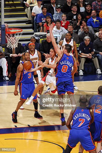 Stephen Curry of the Golden State Warriors goes up for a shot against Danilo Gallinari of the New York Knicks during the game at Oracle Arena on...