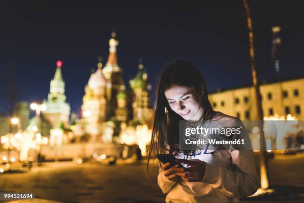 russia, moscow, young woman in the city at night - online church stock pictures, royalty-free photos & images