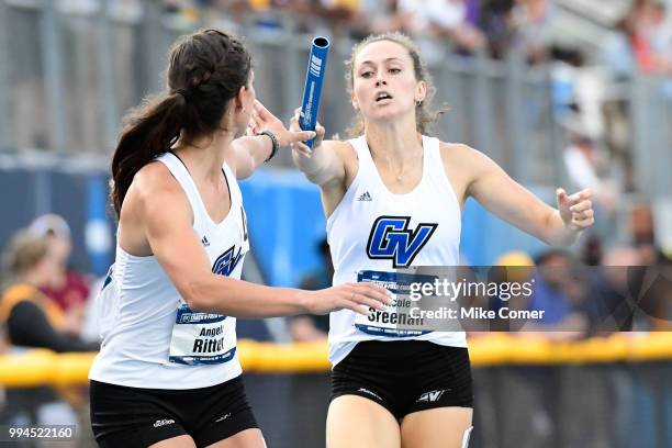 Nicole Sreenan of Grand Valley State University hands the baton to teammate Angela Ritter during the Division II Men's and Women's Outdoor Track and...