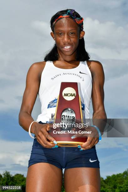 Shanon Kalawan of St. Augustine's celebrates with the trophy during the Division II Men's and Women's Outdoor Track and Field Championships held at...