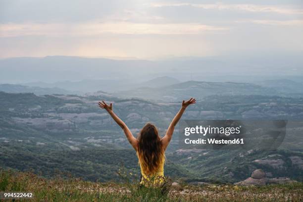 spain, barcelona, back view of happy young woman on montcau mountain - gratitude foto e immagini stock