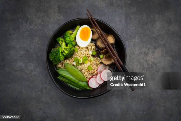 ramen soup with egg, sugar peas, broccoli, noodles, shitake mushroom and red radish - ramen noodles stock pictures, royalty-free photos & images