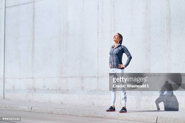 female jogger enjoying sunny day during urban workout - european athletics stock pictures, royalty-free photos & images